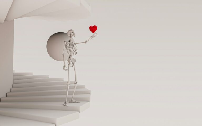 A skeleton holding a red heart in his hand